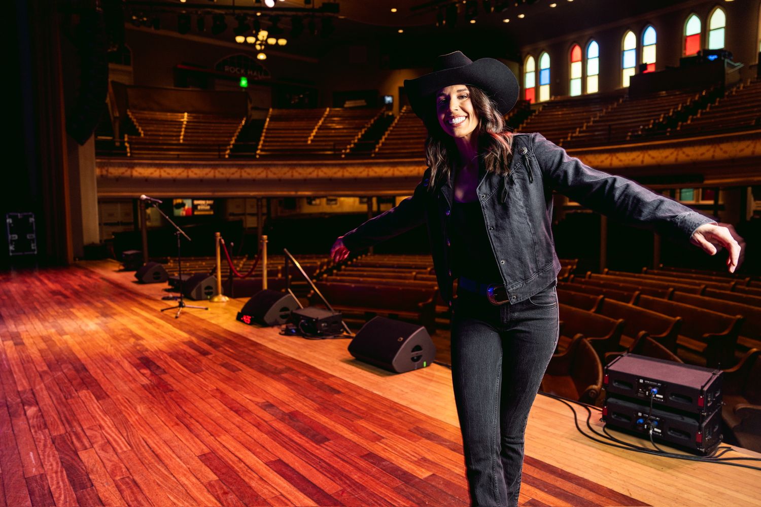 Danae on the Ryman stage, arms wide